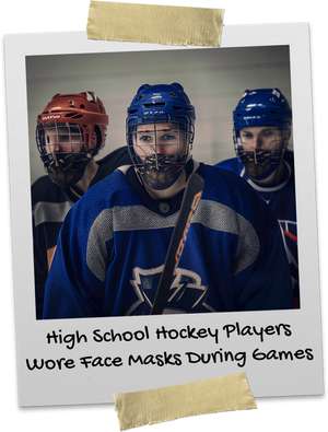 Three high school kids playing hockey with face masks on