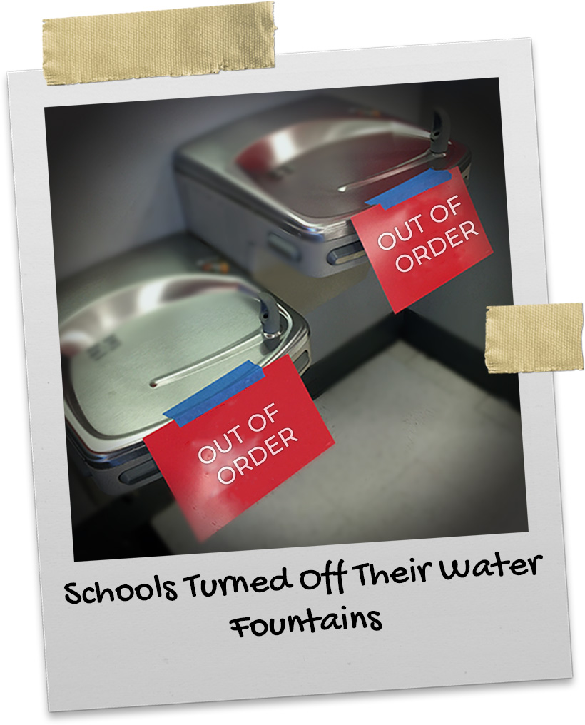Two water fountains with Out of Order signs on them in a school during the pandemic